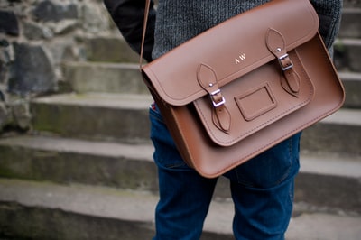 People with brown leather shoulder bag
